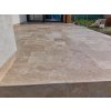 Indoor or outdoor stone tiles Travertine Classic French pattern used on a covered terrace floor with elegant texture.