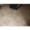 Floor tiles for living room in Travertine Classic French pattern in a cozy lounge area.
