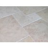 Stone floor tiles in Travertine Light French pattern shown as a close-up interior detail of the laid surface.
