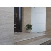 Stone wall tiles Travertine Classic Royal VC frame the main entrance with light beige travertine steps and cladding.
