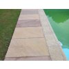 Pool pavers in Sandstone Modak create a straight walkway around the pool.
