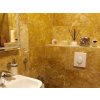 Bathroom tiles Travertine Gold CC create a luxurious full-stone bathroom interior in deep golden tones.
