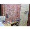 Bathroom wall tiles Travertine Red VC cover the walls with deep red travertine featuring natural patterns.
