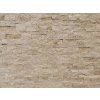 Stacked stone panels Travertine Classic show a close-up of a wall made of natural travertine blocks.
