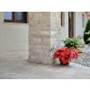 Ledgestone stone Travertine Classic split face wraps exterior columns with subtle beige natural stone texture.