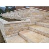 Stone siding Travertine Classic split face highlights a terrace wall with elegant natural travertine layers.