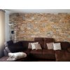 Interior stone cladding Slate Castor adds rustic elegance to a living room wall with soft lighting.