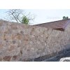 Stone facade Travertine Mandre rock face cladding on garden fence brings Mediterranean charm.
