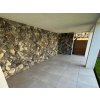Stone facade Marble Black rock face cladding on covered terrace creates modern contrast