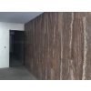 Large-format tiles Travertine Madeira used on interior hallway wall with rich brown travertine tones.