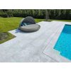 Poolside terrace with light non-slip natural stone surface – Marble Dolphin, sandblasted large-format tiles.