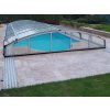 Stone patio with Travertine Mocca French pattern on a pool terrace with cover, garden setting.