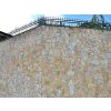 Irregular stone Limestone used as natural wall cladding in light beige tones for garden fence.