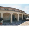 Flagstone cladding Limestone covering columns and arches of building facade in rustic Mediterranean style.