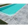 Pool deck pavers — Marble Lagune French pattern with a crisp edge detail beside the water.