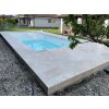 Pool deck pavers in Travertine Classic surrounding a modern pool, overall view with sun loungers and clean joint lines.