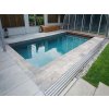 Paving garden slabs Travertine Silver laid neatly around a pool in the garden corner.