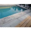 Pool pavers Travertine Silver with coping and drainage channel, providing a safe non-slip edge at the pool