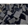 Driveway under construction with medium-format black basalt cobblestones - heavy-duty natural-stone surface.