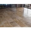 Stone patio look with Travertine Noche used as large rectangular tiles, warm tones creating a smooth continuous floor.