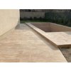 Patio stone pavers in Travertine Mocca on a spacious terrace with steps and a sunken seating area.