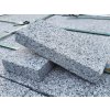 Stack of Rammer Grey granite pavers 20×10×3 cm — sawn edges with uniform sandblasted surface.