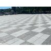 Large plaza paved in Rammer Grey granite 30×15×3 cm — sawn-edge, sandblasted pavers for clean modern grids.