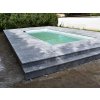 Outdoor pavers in Marble Dolphin 61×40.6×3 cm forming a raised, stepped surround around a compact pool.