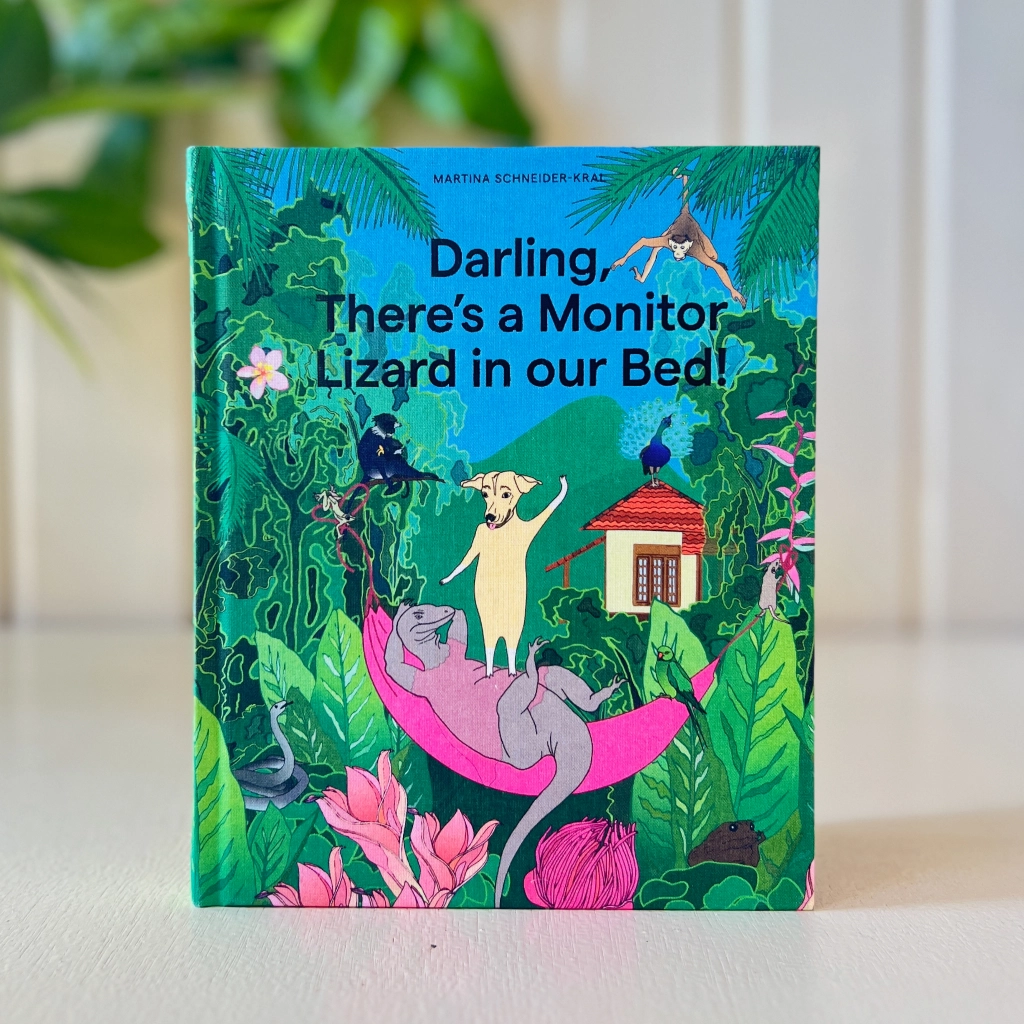 The book Darling, There's a Monitor Lizard in our Bed! on a table