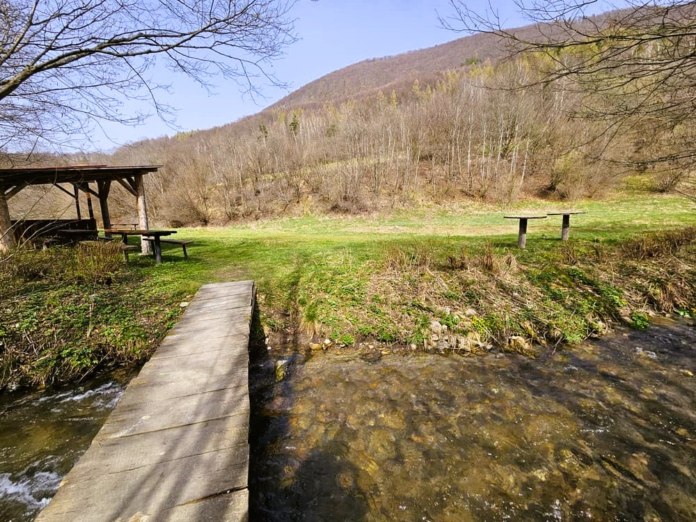 Drevený mostík cez Kojšovský potok a turistické odpočívadlo.