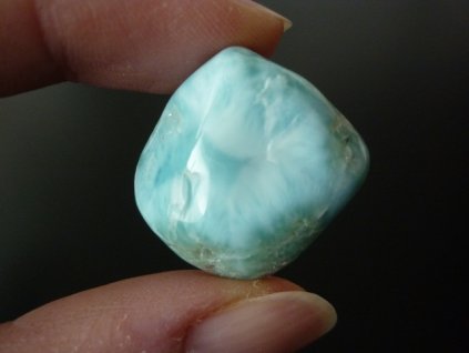 larimar minerál držený v prstech přední strana