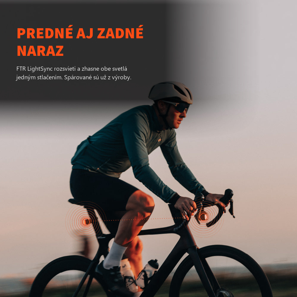 Cestný cyklista za súmraku so synchronizovaným predným a zadným svetlom Magicshine — FTR LightSync