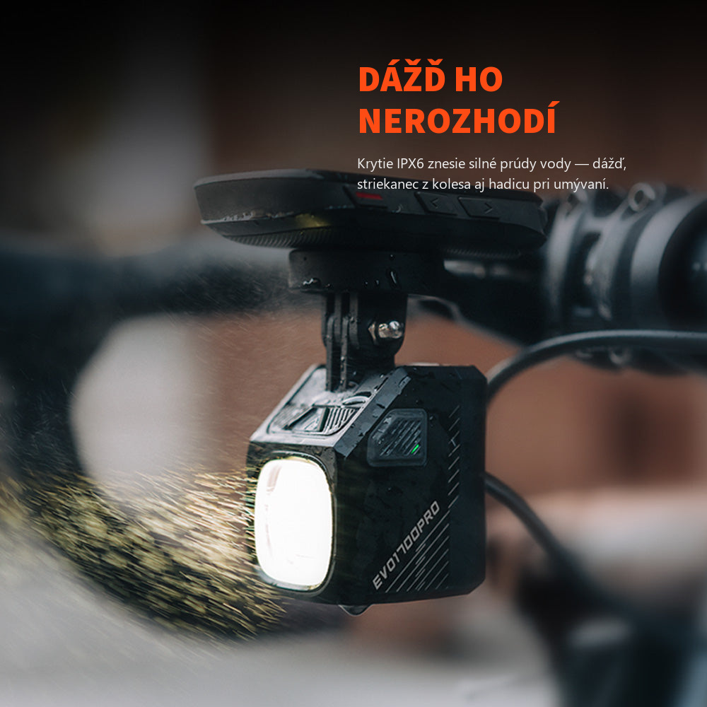 Magicshine EVO 1700 PRO svieti pod cyklopočítačom v daždi, na tele svetla stekajú kvapky vody