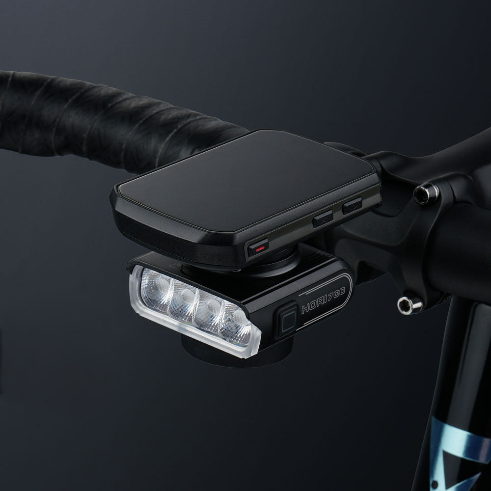 Cyklopočítač nasadený nad predným svetlom Magicshine HORI 700 na jednom držiaku pri predstavci bicykla