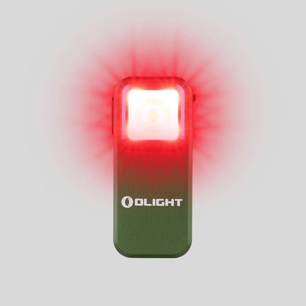 Olight Oclip Green svieti načerveno, okolo hlavy svetla sa rozlieva sýto červená žiara nad zeleným telom