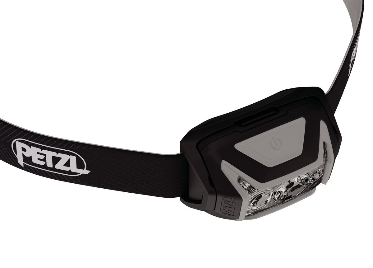 Petzl ACTIK CORE — pohľad zhora na ovládacie tlačidlo a svetlý fosforeskujúci reflektor