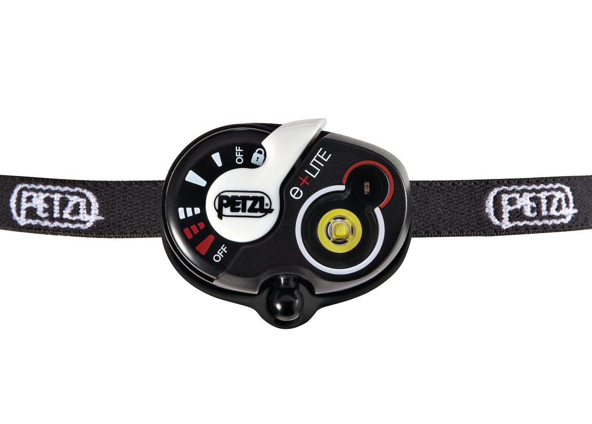 Petzl e+LITE — čelný pohľad na otočný volič s poistkou proti nechcenému zapnutiu, bielou a červenou LED