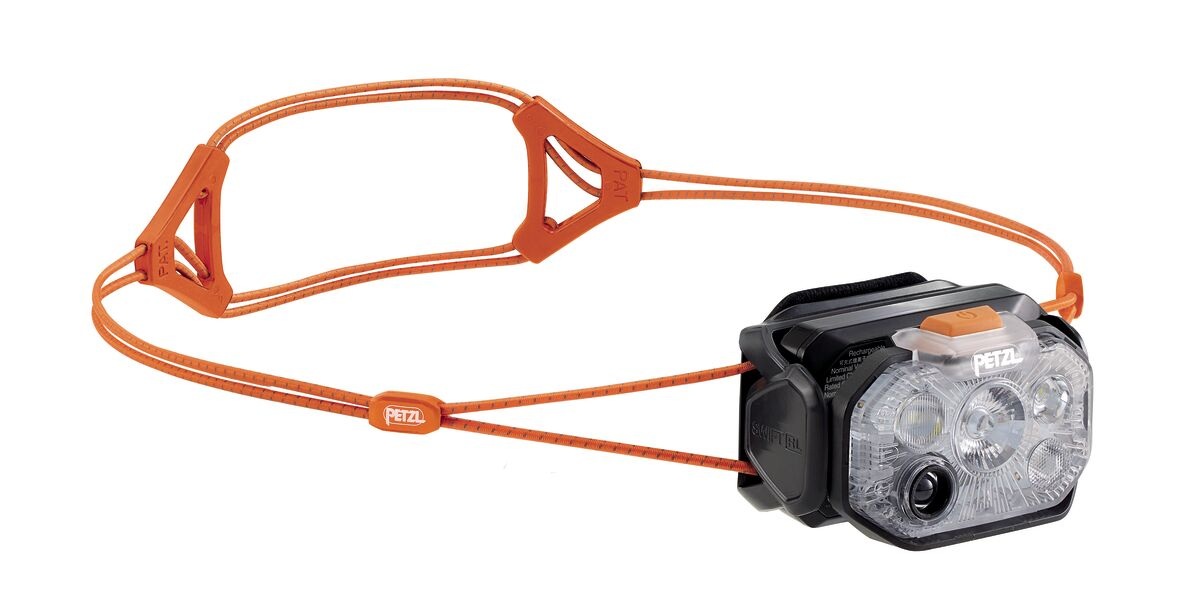 Petzl SWIFT RL bez komfortnej výstuže — čelovka s dvojicou tenkých oranžových elastických šnúr a plastovými rozvádzačmi deleného strihu