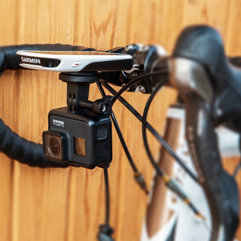 Magicshine TTA držiak na cestnom bicykli, hore cyklopočítač Garmin a pod ním zavesená kamera GoPro cez adaptér