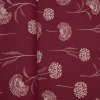 Režná látka v metráži s motivem pampelišek na červeném podkladu