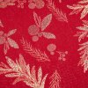 Lurexová látka s vánočním motivem zlatých lístků na červeném podkladu.