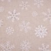 Látka s vánočním motivem vloček na béžovém podkladu