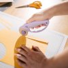 57c459f10af2e38289d6d148e5533b2a 1066464 designer explore rotary cutter ultra lilac in use 03 1x1