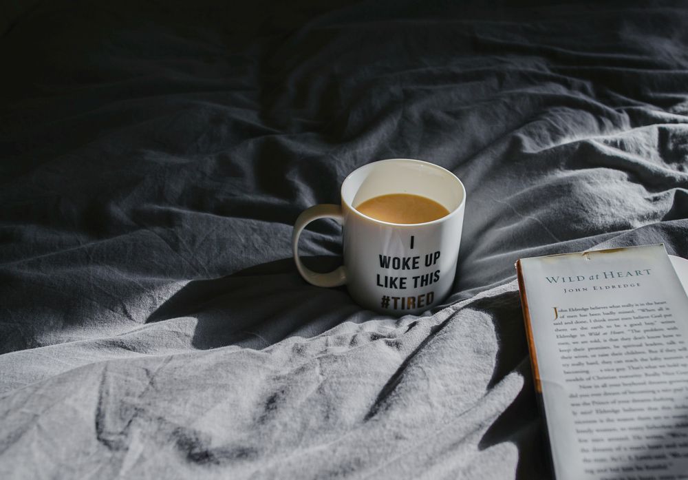 Cup of coffee in a bed