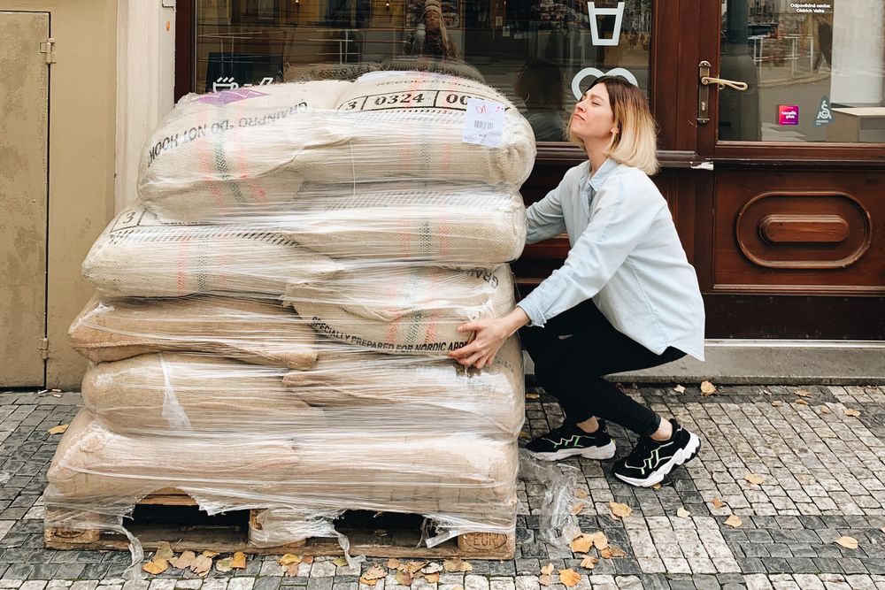 Girl and a pile of coffee bags Girl and a pile of coffee bags