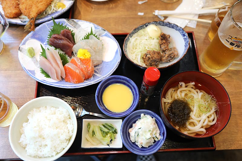 Sašimi z tuňáka, lososa, kadžiki maguro, tai, k tomu pár kousků karaage se svěžím strouhaným zelím, rýže, miska udonu, pivo Kirin. Menší oběd v Hokkaisuisan, klasickým a dobrým japonským lokále v Šibuje v Tokiu. 