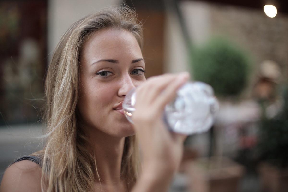 selective-focus-photo-of-smiling-woman-drinking-water-from-a-3763929