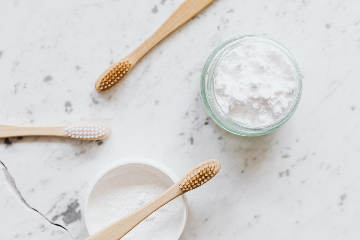 jars-with-tooth-powder-and-wooden-toothbrushes-4202388