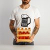 bearded tattooed man holding small crate with six unmarked glass bottles craft lager beer drink white wall