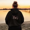 back view mockup of an ai created woman wearing a hoodie at a lake m52592